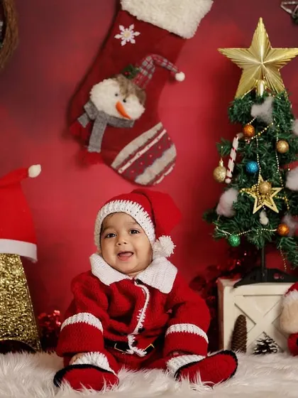 This little boy is all smiles in his Santa suit. Holiday-themed mini-sessions are a wonderful way to create lasting memories and greeting cards.
