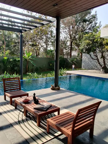 The sun-soaked pool deck is the perfect island for a morning cup of coffee, offering a tranquil view of the water and the surrounding tropical garden.