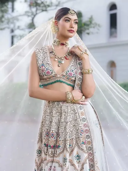 The flowing veil adds a touch of magic to this dreamy bridal look.