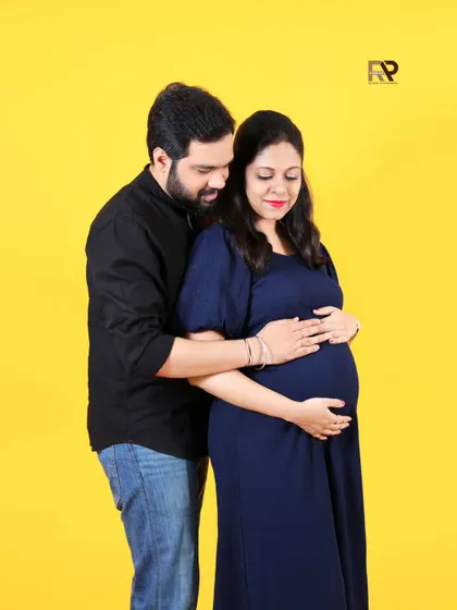 A variation of our bright and modern couple's shoot. The dad-to-be embraces his partner from behind, both sharing a happy and loving moment.