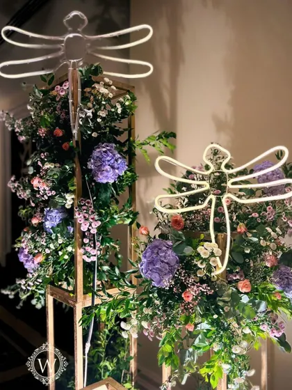 For this whimsical garden reception, we used glowing LED dragonflies and birds nestled among pastel floral arrangements. These unique lighting elements added a touch of magic and sophistication to the decor.