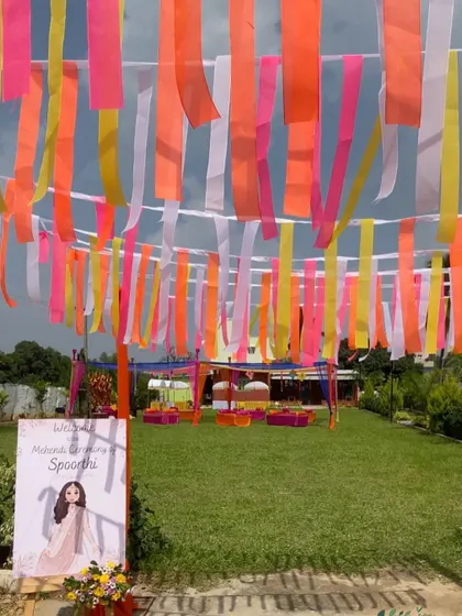 The entrance to the Mehendi ceremony, where guests walk under a canopy of fluttering, colorful ribbons.
