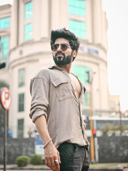 A classic men's fashion shot on a city street, with the out-of-focus background highlighting the model.