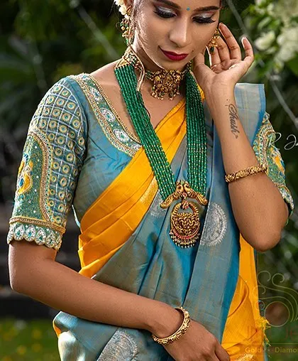 A close-up showcasing the intricate embroidery on the blouse of this beautiful silk saree.