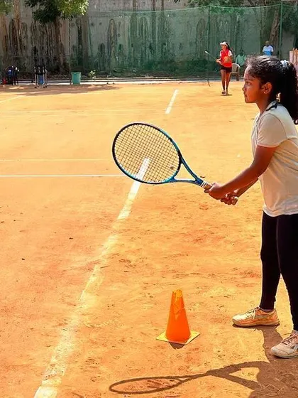 Another shot of a junior player during a practice session, demonstrating the concentration and form we cultivate in our athletes.