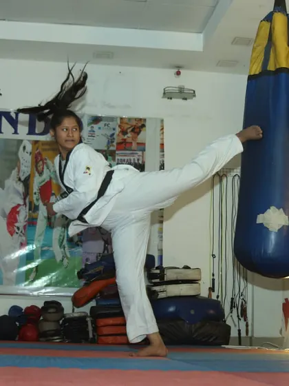 A student practices a powerful side kick on a heavy bag in our dojang. We focus on developing proper form and explosive power in every technique.