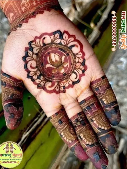 A close-up of a beautiful mandala design with a lotus at its center. The rich, dark color shows the quality of our organic henna paste.
