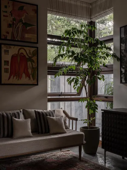 This living room corner at Pràna is a testament to bringing the outdoors in. The large windows and indoor plants make the space feel like a serene, sophisticated conservatory.