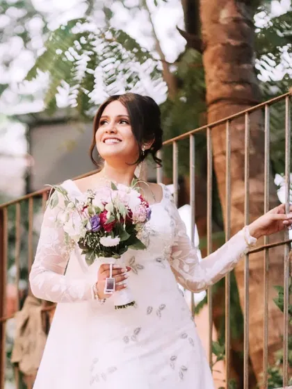 A beautiful, sun-kissed shot of the bride. Her joyful expression and the soft, romantic hairstyle create a look of pure happiness.