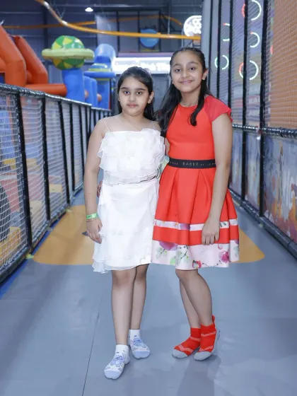 Two friends in their party dresses, enjoying a celebration at Wobble World.