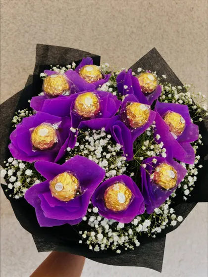 A top-down view of the purple Ferrero Rocher bouquet, focusing on the pattern and rich color of the chocolate "blossoms".