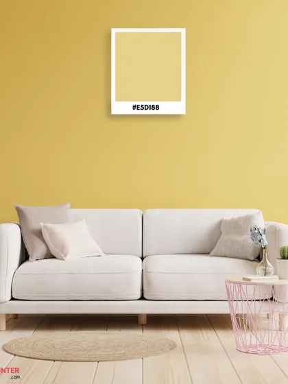 A cheerful yellow wall brings energy and brightness to this living room. Paired with a neutral sofa, it creates a balanced and inviting space.