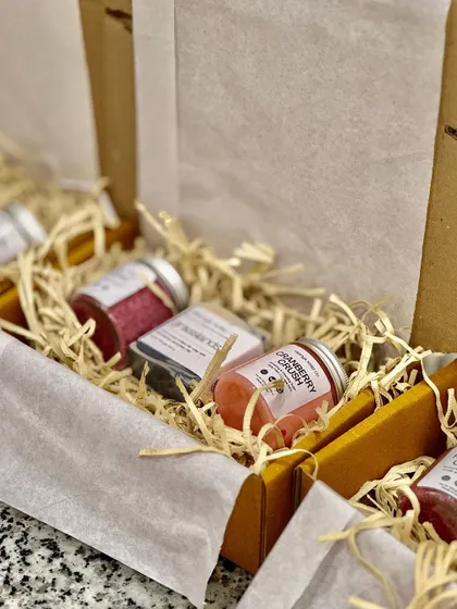 Another view of our hamper assembly line, showing how we carefully arrange products to create a visually appealing and well-balanced gift box.