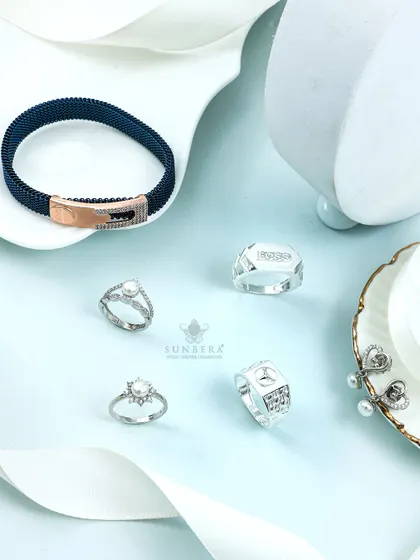 Shimmer in silver with this diverse collection. It includes a men's mesh bracelet, pearl rings, and statement earrings, demonstrating the breadth of our design capabilities.
