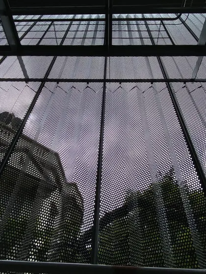 Looking up through the building's new skin, the sky is filtered and the reflection of the historic structure next door is captured. This detail shows how our interventions aim to connect the building to its context in new and unexpected ways.