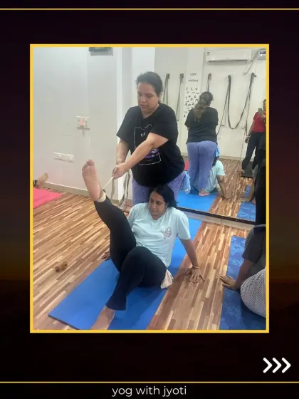 Yoga with a little help from my friends. Here, I am assisting a student to deepen her leg stretch, showing how partner work can enhance flexibility.