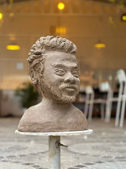 The finished bust, waiting in the studio. The play of light and shadow on the sculpted features brings it to life.