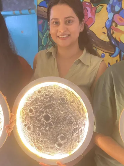 Another happy student from our 3D moon workshop, holding her unique, handmade lamp.
