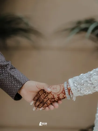 A close-up of Gaurav and Mansi holding hands, a simple yet powerful symbol of their union.