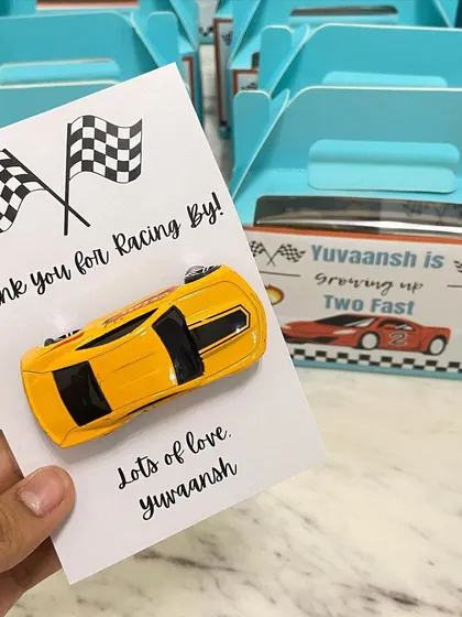 It's all in the details. For a "Two Fast" themed second birthday, we created these custom "Thank you for Racing By" return favours, complete with a toy car for each little guest.