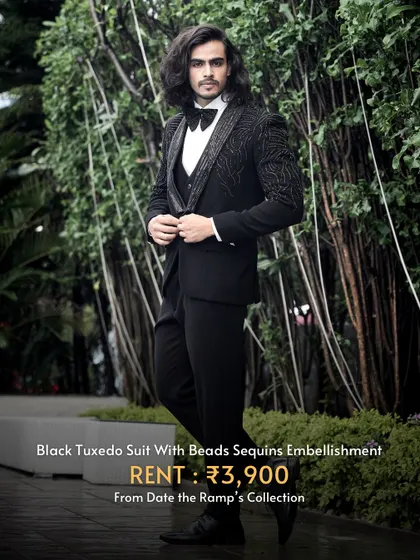 This black tuxedo suit is elevated with bead and sequin embellishments, adding a touch of modern flair to a classic silhouette.