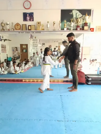 A handshake for a new yellow and green belt.