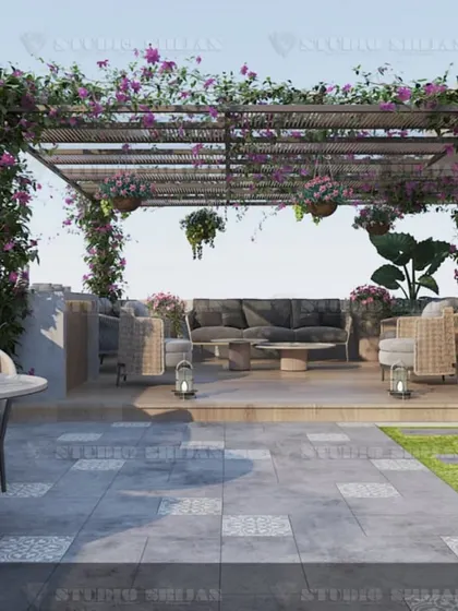 This wide view of the Rajouri Garden terrace shows how we zone larger outdoor areas. We created separate zones for lounging and dining, all unified by the lush greenery and natural materials.