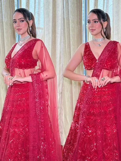 A full-length view of the red cocktail lehenga. The look is bold, confident, and perfect for a bride who wants to shine.