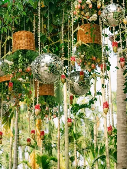 The intricate details of the hanging decor, where modern disco balls meet traditional Indian floral strings, creating a visual feast.