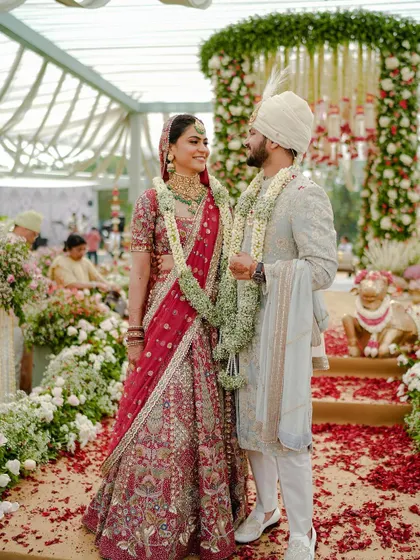 A classic portrait of the bride and groom at their wedding ceremony, surrounded by a sea of flowers. This is the kind of timeless image every couple dreams of.