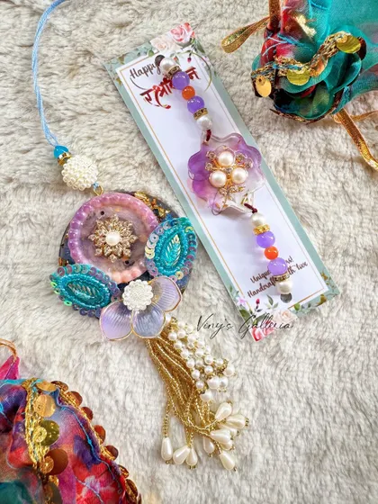An elegant lumba and matching rakhi set, handcrafted with intricate details and beautiful beads. This is a perfect way to celebrate the bond with both your brother and sister-in-law.