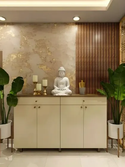 This foyer design creates a tranquil welcome with a white Buddha statue as the centerpiece. The console is flanked by large plants, set against a backdrop of gold-flecked wallpaper and wood paneling.