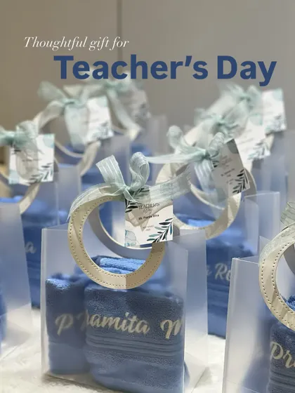 Another shot of the thoughtful Teacher's Day gifts, showcasing the soft blue personalized towels ready to be gifted.