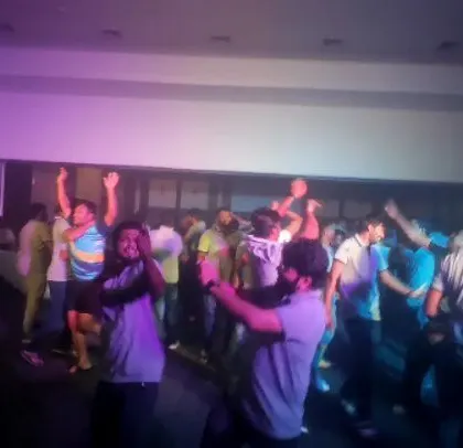 The crowd enjoying the regional hits at their company party.