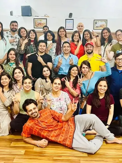 The whole Kula together. A large group photo filled with smiles, peace signs, and the wonderful chaos of our community.