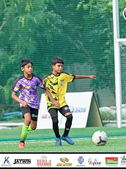 A player looks to make a pass while being closely marked.