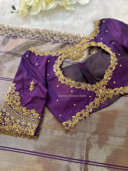 The back of the purple blouse features a beautiful heart-shaped cutout with a central motif.