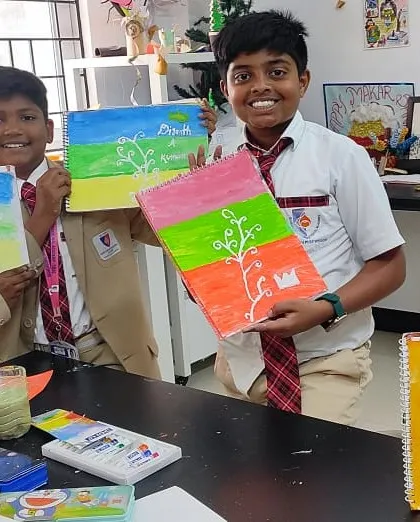 Happy students show off their vibrant pastel drawings, created during a fun and engaging art class.