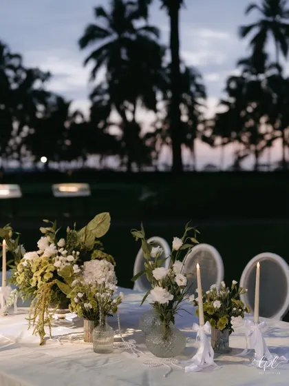 A close-up of the elegant white and green tablescape from a Goa dinner party.