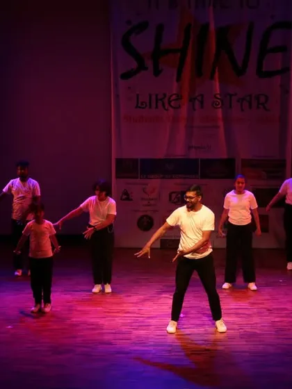 An instructor leading the class through a sequence on stage.