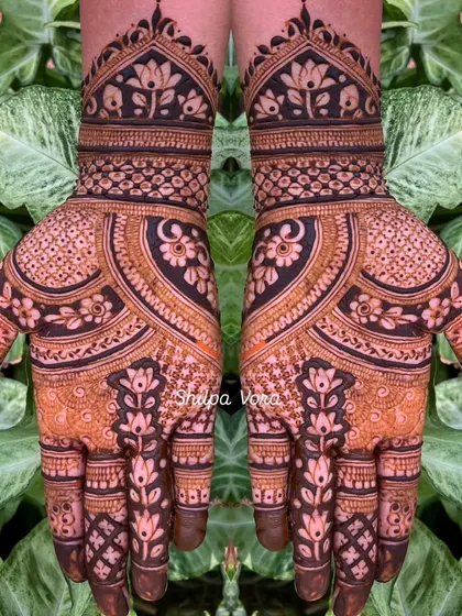 A symmetrical design with a central lotus motif and a mix of modern patterns.