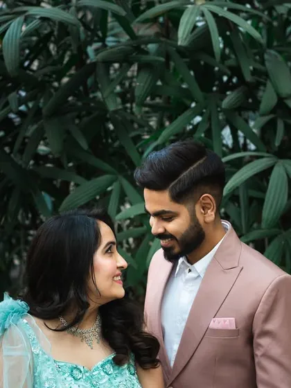 A classic couple portrait from a cocktail event. The natural green background provides a nice contrast to their formal wear.