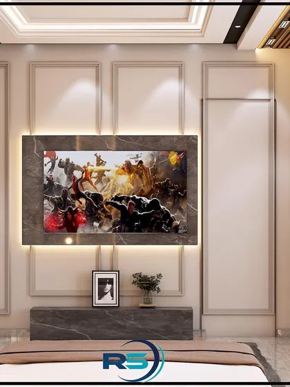 This completed bedroom project features a floor-to-ceiling media wall with decorative molding and backlighting. To the side, a door is cleverly concealed within the paneling, leading to a walk-in closet or bathroom.