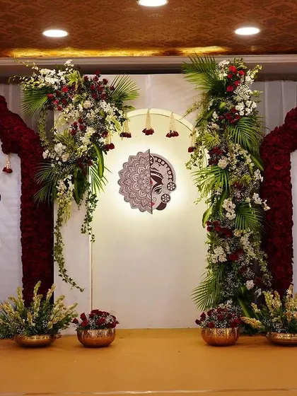 The full stage setup for the "Mitakshi" naming ceremony. The symmetrical design with peacock illustrations and a central Durga motif created a balanced and spiritually significant backdrop.
