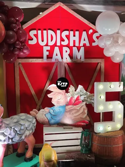A close-up of the 'Sudisha's Farm' backdrop, featuring a cute sheep, Peter Rabbit, and a lit-up number '5'.
