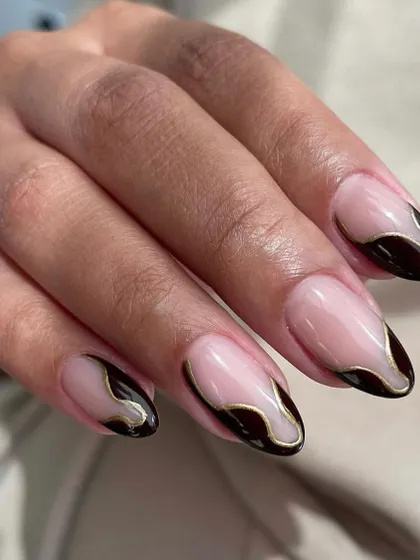 Abstract and edgy. We used a fine-liner brush to create this melted, dripping effect with black polish and a gold chrome outline over a nude base.