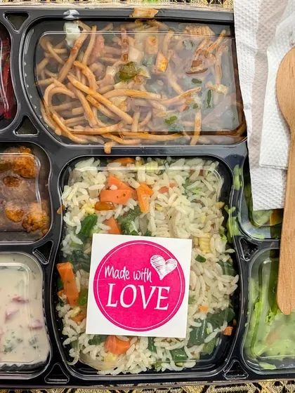 Every meal is packed with love. A close up of one of my meal trays, complete with a wooden spoon and napkin, ready to be enjoyed.