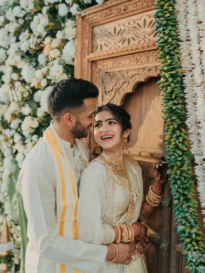 An intimate portrait of the couple during their South Indian Haldi, showcasing their beautiful traditional outfits and the genuine happiness they share.