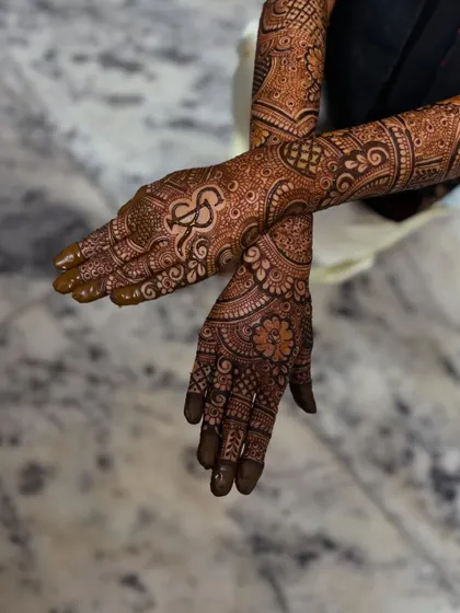 A crossed-hands pose showing the personalized initial.