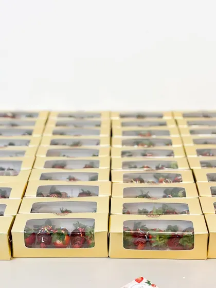Rows of our fresh strawberry birthday favours, packed and ready for a party. We take pride in sourcing the best ingredients for all our creations.